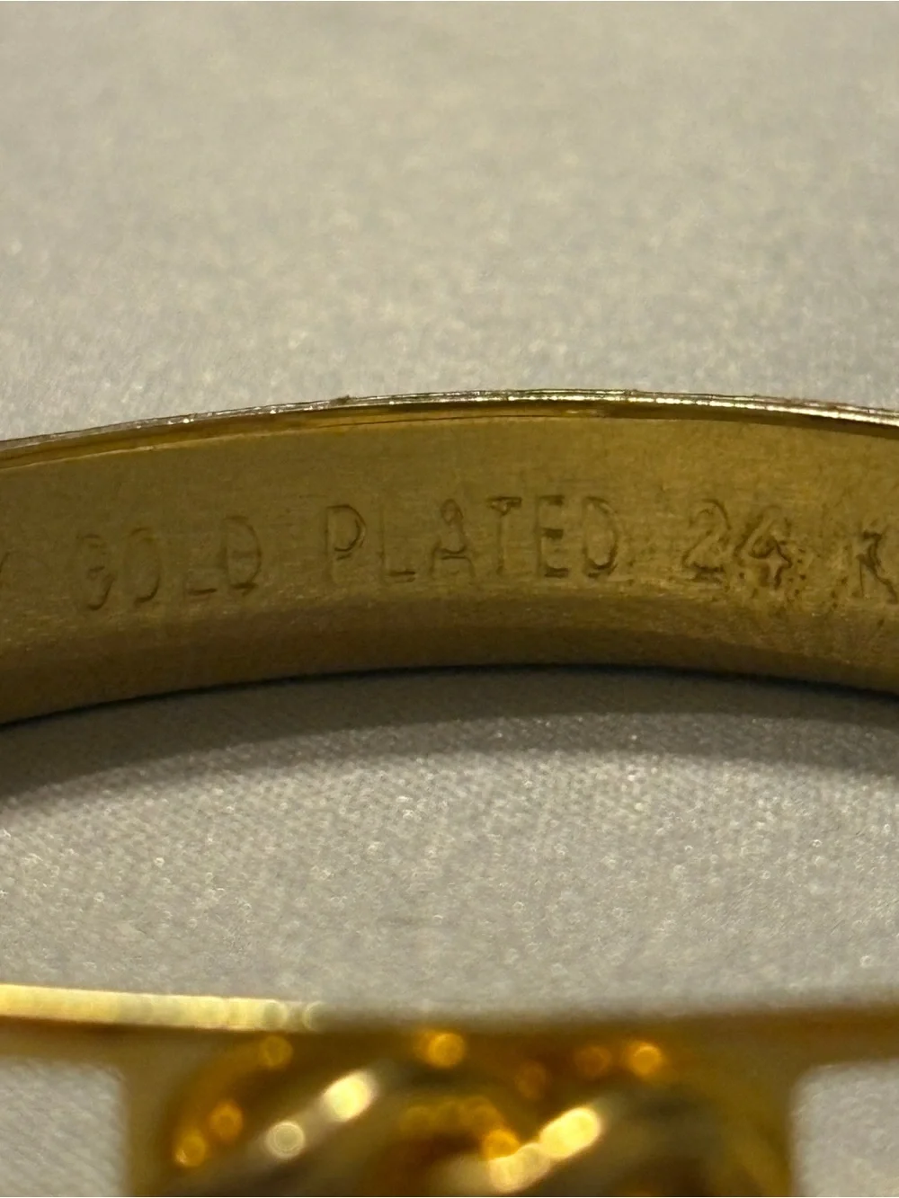 Gold Tone Knot Accent Bangle Bracelet